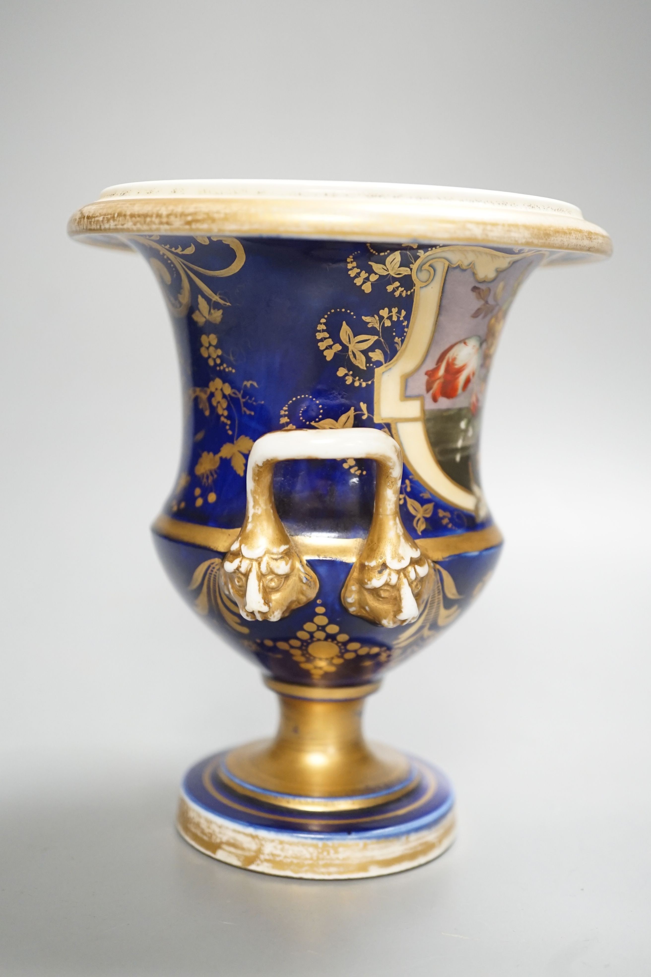 A Herculaneum two handled pedestal campana shaped vase, painted with basket of flowers, within a shaped cartouche on a cobalt blue and gilt ground, c.1815, height 14.5cm